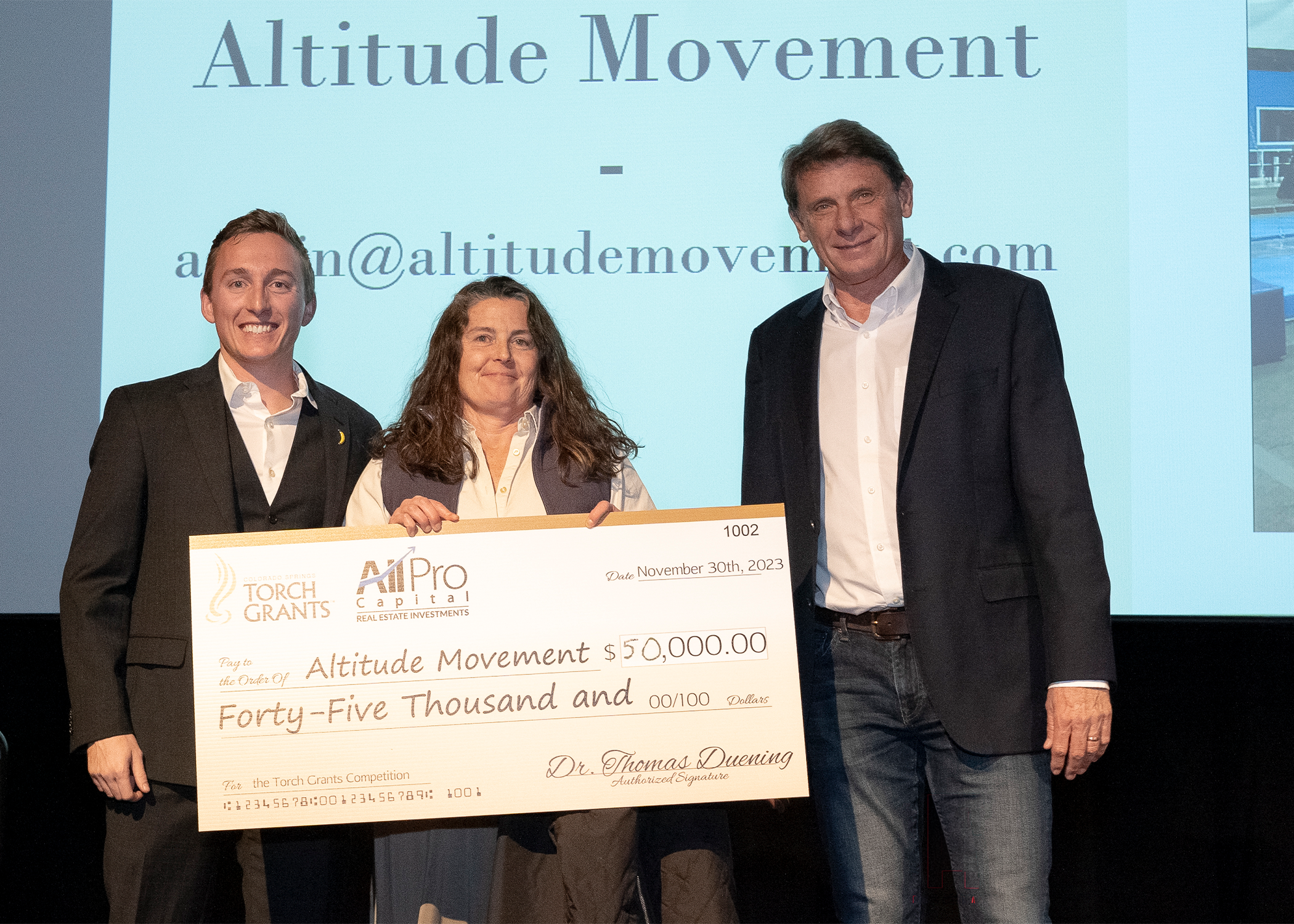 Altitude Movements founder, Michelle Freddolino, receiving her Torch Grant Check